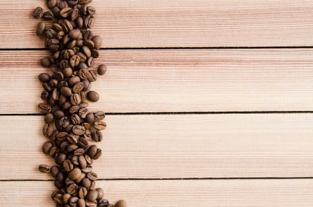 roasted coffee beans on wooden background