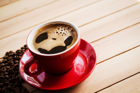 cup of coffee on wooden background