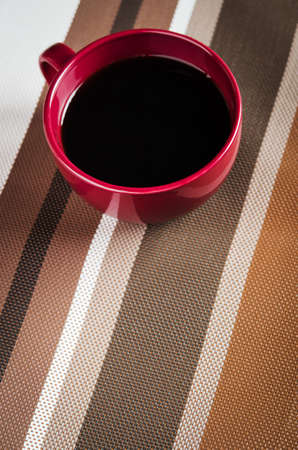 one red cup of coffee on kitchenの写真素材