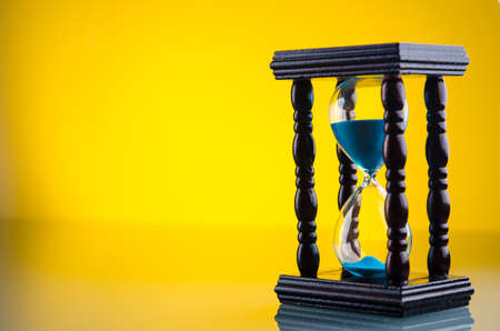 retro hourglass on glass tableの写真素材