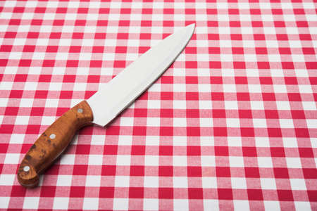 Big kitchen knife on tableclothの写真素材