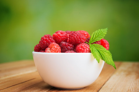 fresh raspberries in plate on outdoors