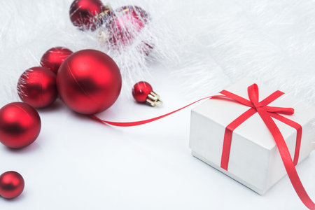 Christmas red gift box with balls on white backgroundの写真素材