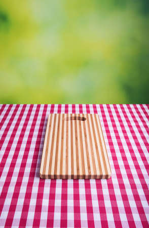 Cutting board on tartan tableの写真素材