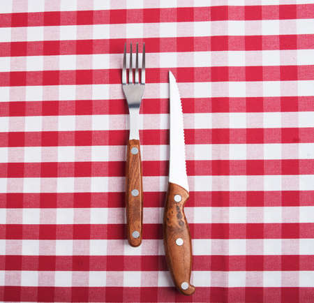 fork and knife on tableclothの写真素材