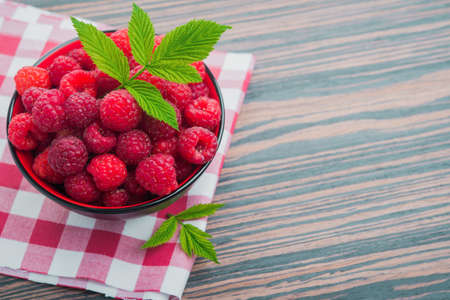 red raspberry with green leaf on backgroundの写真素材