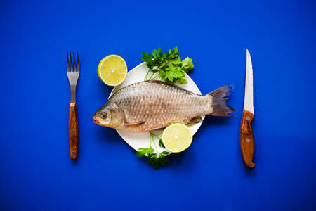 fresh fish carp on white plateの写真素材