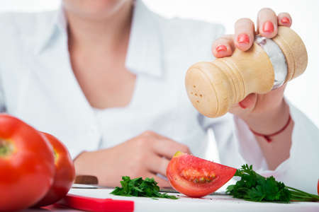 female chef preparing tomato saladの写真素材