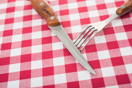 fork and knife on kitchen tableの写真素材