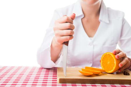 woman with knife and fresh orangeの写真素材