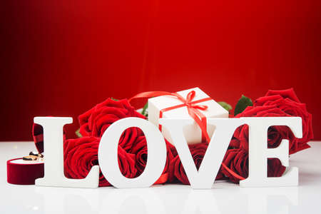 Concept photo of Valentine Day background. Rose, rings and gift.の写真素材