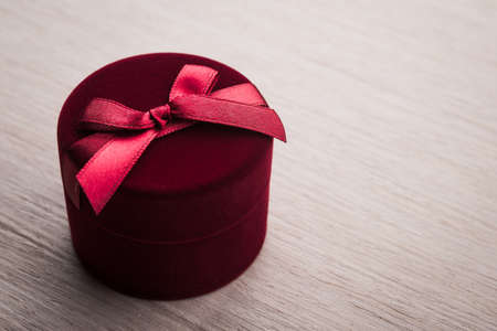 Red gift box with bow on backgroundの写真素材