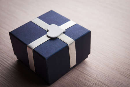 Gift box with white heart shape backgroundの写真素材