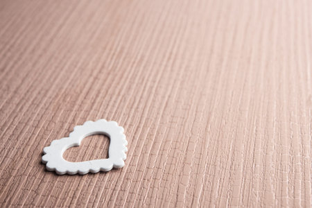 One white heart symbol on wooden background