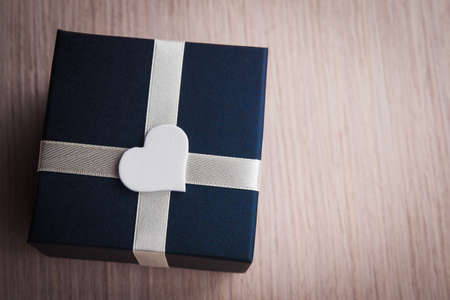 Gift box with white heart shape backgroundの写真素材
