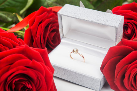 Red roses and ring with diamond on backgroundの写真素材