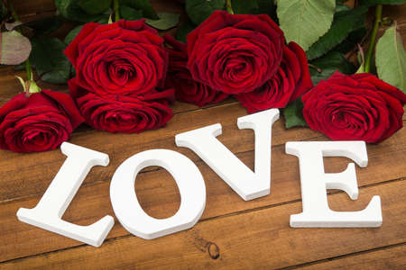 Composition of love white words and rose. Valentine Day background.の写真素材