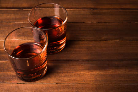 Cognac glasses on wooden tableの写真素材