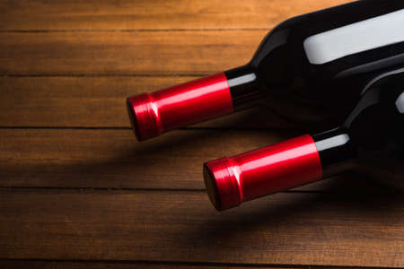 Two wine bottles on wood backgroundの写真素材