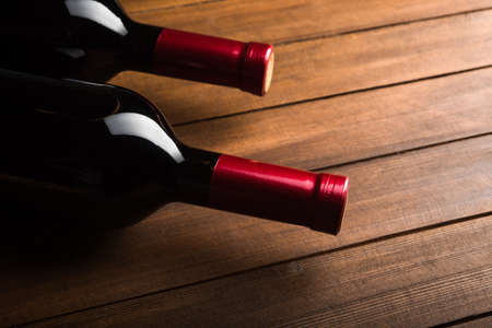 Two wine bottles on wood backgroundの写真素材