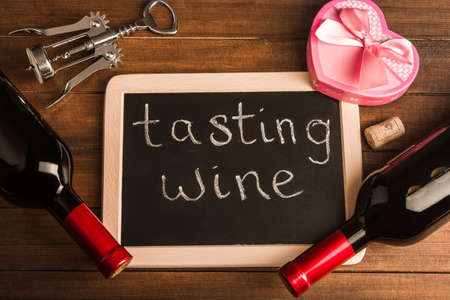 tasting wine on board with a gift and wineの写真素材