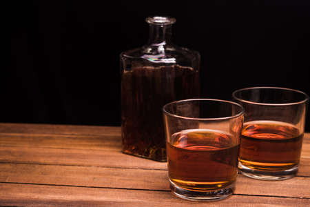 Whiskey drinks on wood tableの写真素材