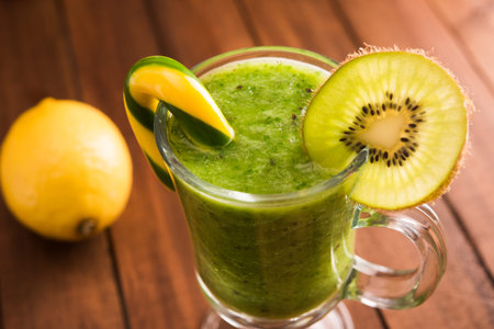 Fat burning kiwi cocktail on wooden backgroundの写真素材