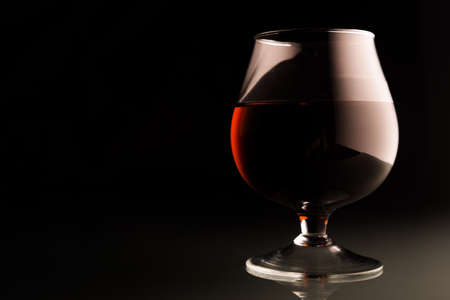 Glass of brandy on black backgroundの写真素材