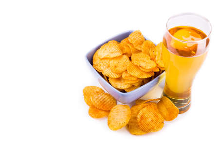 Glass of beer and chips isolated on white backgroundの写真素材
