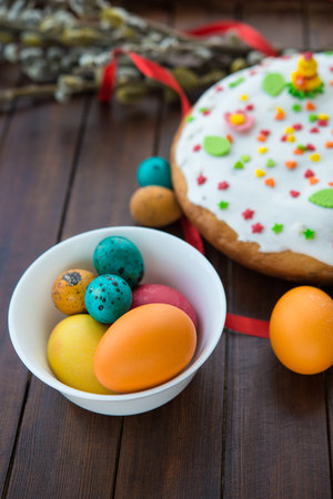 Easter eggs and cake on wood table