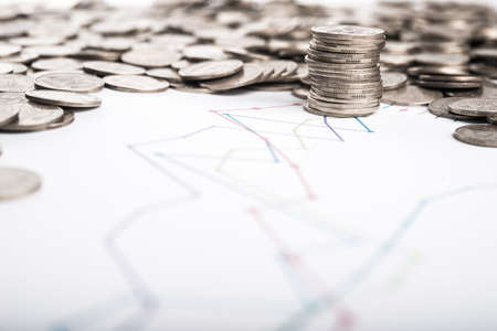 Stack of coins and graph backgroundの写真素材