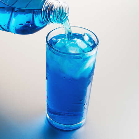 Pouring cold water into glassの写真素材