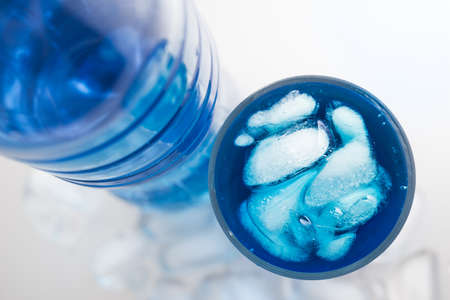 Cold glass water with ice on white backgroundの写真素材