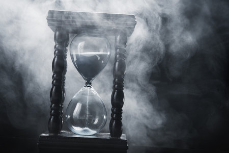 Hourglass clock on black backgroundの写真素材
