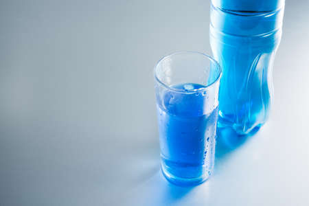 Bottle and glass of water on white backgroundの写真素材