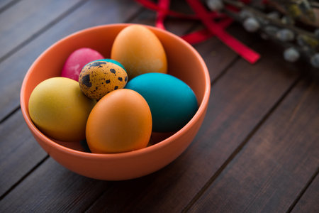 Easter eggs and willow tree on white wood tableの写真素材