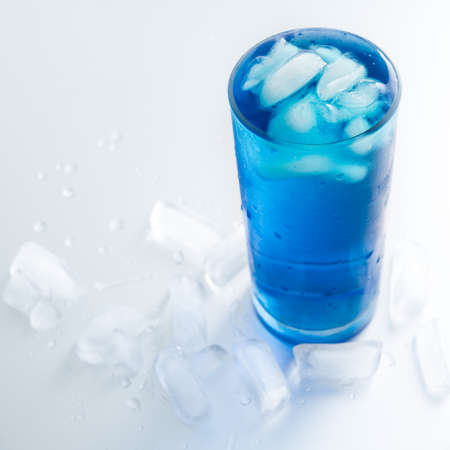 Cold glass water with ice on white backgroundの写真素材