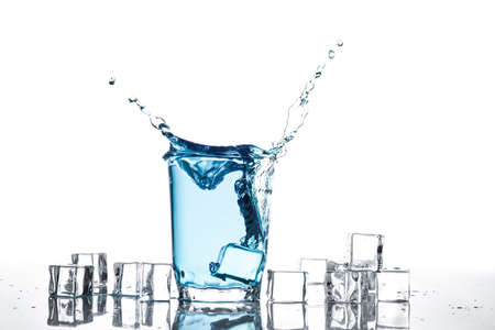 Splash of water in glass isolated on white backgroundの写真素材