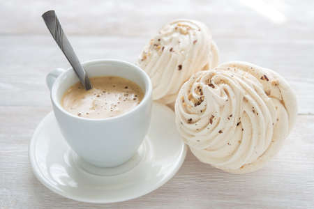Coffee cup and cake on white wood table backgroundの写真素材