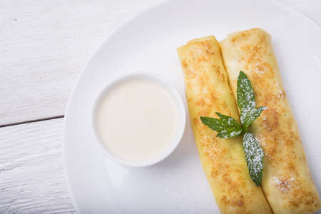 pancakes with cottage cheese and gren mint on white plate backgroundの写真素材