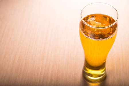 Glass of beer on wooden tableの写真素材