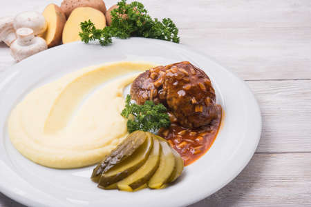 Mashed potatoes with meat cutlet on white plateの写真素材