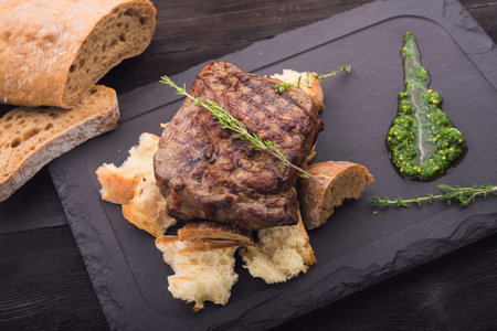 beef steak on white table in restaurant wood tableの写真素材