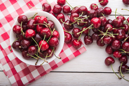 Fresh cherries in a white plate. Top view.の写真素材