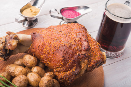 restaurant supply pork shank with potatoes and a glass of beerの写真素材