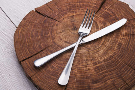 fork and knife on a wooden standの写真素材