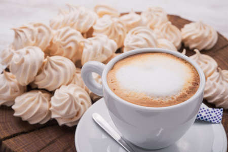 cup of cappuccino with zephyr on backgroundの写真素材