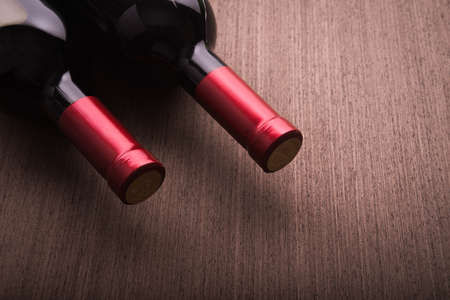 Two wine bottle on wood backgroundの写真素材
