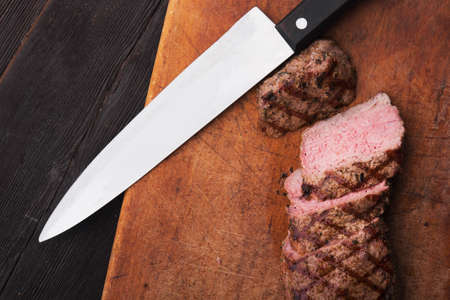 beef steak on with fresh salad on stone board backgroundの写真素材