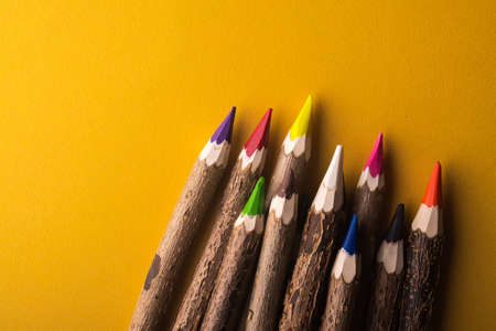 wood color pencils on yellow backgroundの写真素材